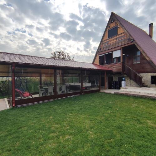 a large house with a large patio and a yard at City Break in Petrovaradin