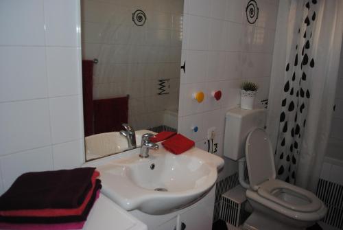 a bathroom with a sink and a toilet and a mirror at Lui in Makarska