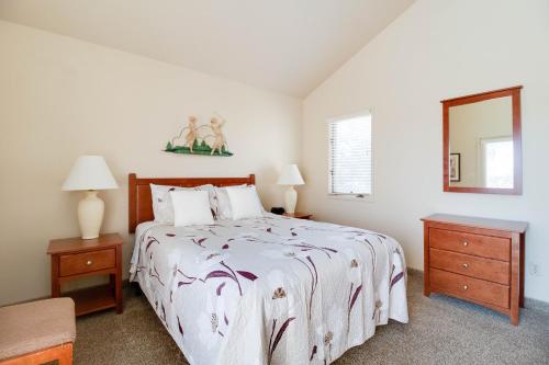 a bedroom with a bed and two night stands and a mirror at Deschutes River View Eagle Crest in Redmond