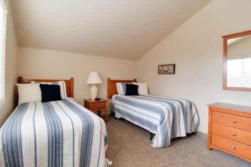 a bedroom with two beds and a dresser at Deschutes River View Eagle Crest in Redmond
