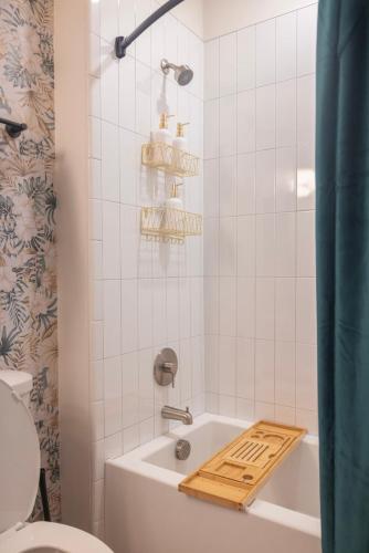 a bathroom with a white tub and a toilet at Two Story Penthouse, 2 Bedrooms with 2 and a half bathrooms, 2 Balconies, Skyline View, Pool in Richmond