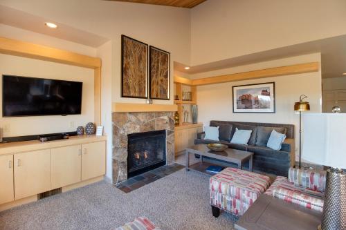 a living room with a couch and a fireplace at Deschutes River View Eagle Crest in Redmond