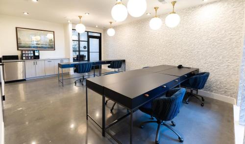a meeting room with blue chairs and a table at 2 Story Penthouse 2 Balconies, Skyline View, Pool in Richmond