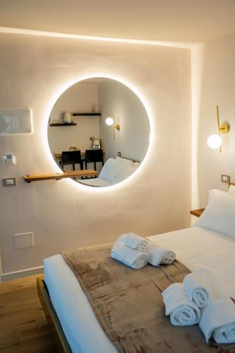 a bedroom with a bed with a round mirror at Luxury Fire Home - Catania in Catania