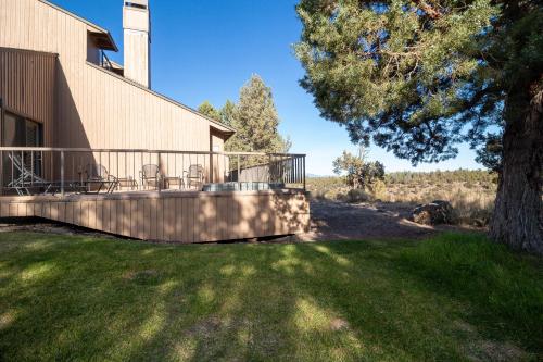 a house with a deck with chairs on it at Deschutes River View Eagle Crest in Redmond