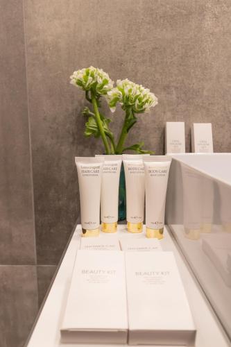 a group of three vases with flowers on a table at Domus Aurea Luxury Suites in Rome