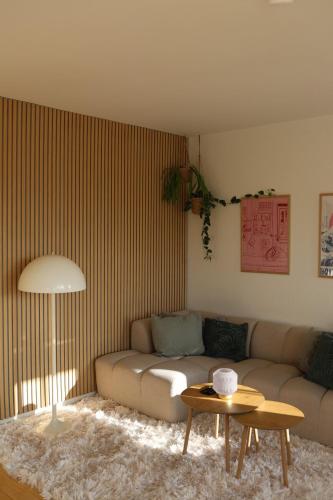 a living room with a couch and a table at Cosy appartment near city, beach, metro & airport in Copenhagen