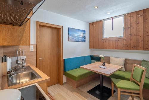 a small kitchen with a table and a sink at Haus Birkenheim in Sölden