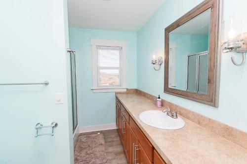 a bathroom with a sink and a mirror at Oceanside, Wild Horses, Private Pool, Hot Tub -4x1941, A Sense of Porpoise in Knotts Island