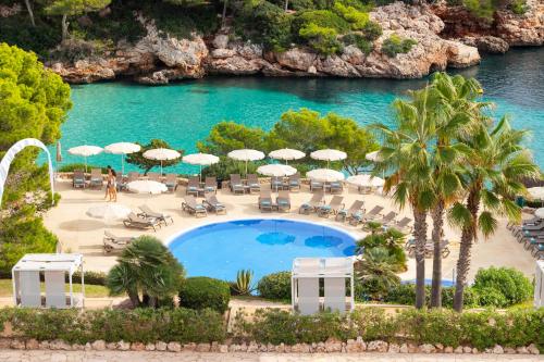 an aerial view of a resort with a swimming pool at Inturotel Cala Esmeralda Beach Hotel & Spa - Adults Only in Cala d´Or