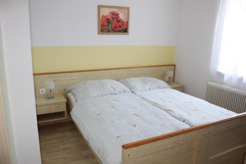 a bedroom with a bed and two night stands at Gästehaus Schneider in Illmitz