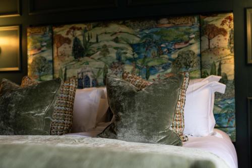 a bedroom with a bed with pillows and a wallpaper at Aynsome Manor in Cartmel