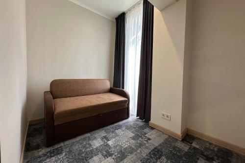 a chair sitting in a room with a window at "Гірський Континент" Hotel Restaurant & SPA in Yablunytsya