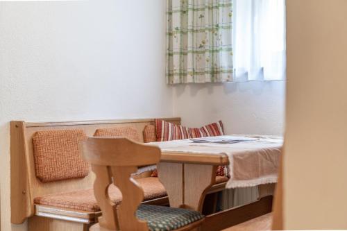 a room with a table and a chair and a window at Haus Birkenheim in Sölden