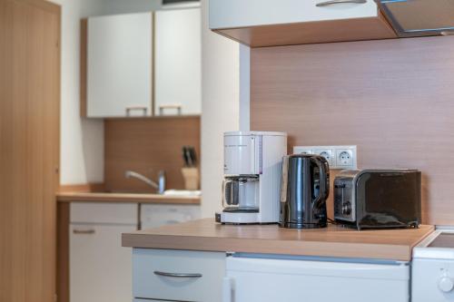 a kitchen counter with two coffeemakers on top of it at Haus Birkenheim in Sölden