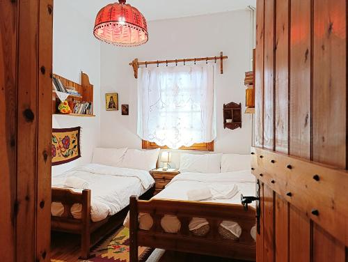 a living room with two beds and a window at Woodman’s home in Vlatanéoi