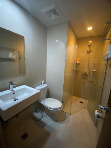 a bathroom with a sink and a toilet and a shower at A&G Condotel at 101newport Near NAIA T3 in Manila