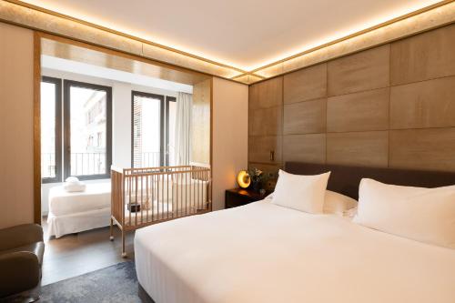 a bedroom with a large white bed and a window at Almanac Barcelona in Barcelona