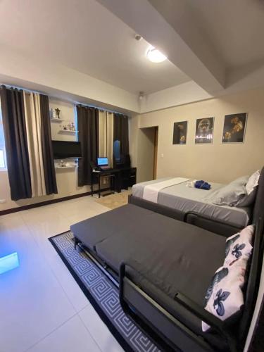 a bedroom with two beds and a living room at A&G Condotel at 101newport Near NAIA T3 in Manila