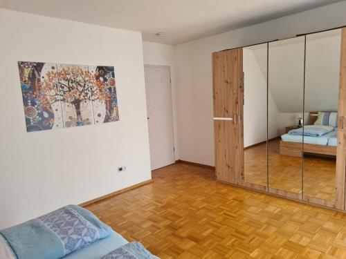 a room with a sliding glass door and a bedroom at Im Gottesgarten am Obermain in Zapfendorf