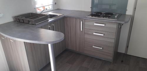 una cocina con fregadero y encimera en omer novela, en Port-la-Nouvelle
