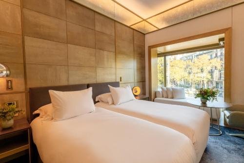 a bedroom with a large white bed and a window at Almanac Barcelona in Barcelona