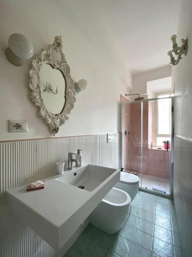 a bathroom with a tub and a toilet and a mirror at Casetta Roma San Giovanni in Rome
