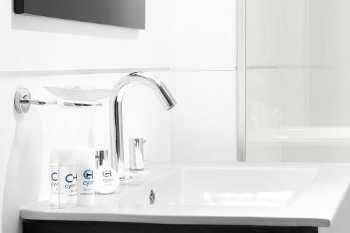 a bathroom with a sink and a faucet at CH Recoleta Suites in Buenos Aires