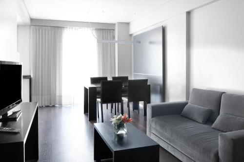 a living room with a couch and a table at CH Recoleta Suites in Buenos Aires
