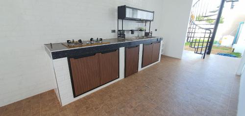 a kitchen with a sink and a counter top at พูลวิลล่าเขาใหญ่ฮิลล์ Pool Villa Khaoyai Hill in Pong Talong