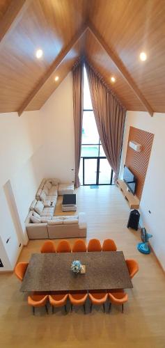 a living room with a couch and a table and chairs at พูลวิลล่าเขาใหญ่ฮิลล์ Pool Villa Khaoyai Hill in Pong Talong