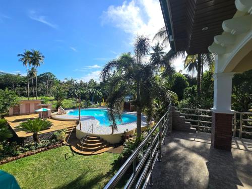 a view of a swimming pool from the balcony of a house at Bregman Residance in Plaridel