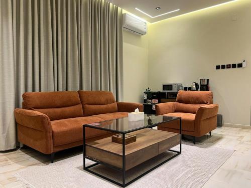 a living room with two couches and a coffee table at سويت بغرفة نوم وصالة جانبية in Hail