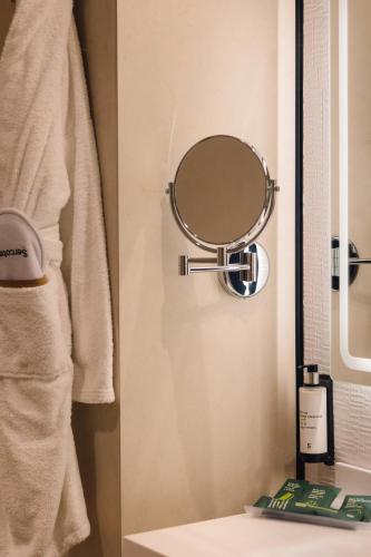 a bathroom with a mirror next to a sink at Sercotel Amistad Murcia in Murcia
