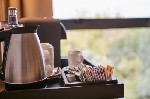 a tea kettle sitting on a counter with toothbrushes at Sercotel Amistad Murcia in Murcia
