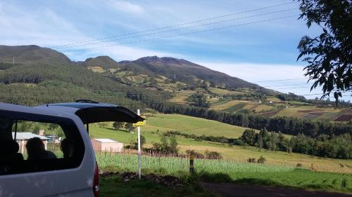 a car driving down a road with a view of a mountain at Hostal las margaritas in Pasto