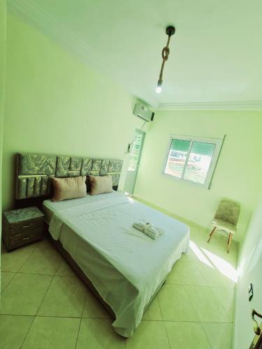 a bedroom with a bed and a chair in it at Appart Hotel Fes - Joud Families & Travelers in Fès