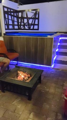 a fire pit in the middle of a room with stairs at De la llanura 31 in Hermosillo