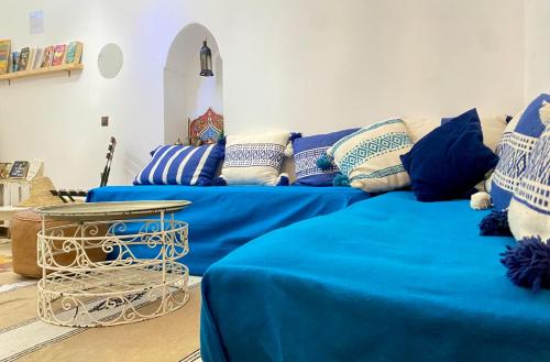 a living room with two blue couches and a table at Dar La Casbah Private Riad Stay with Moroccan Breakfast in Tangier