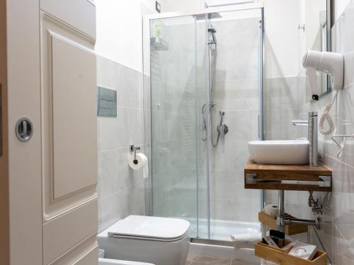 a bathroom with a shower and a toilet and a sink at Villa Demetrio Ars Hotel in Piacenza