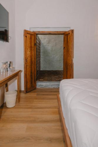 a bedroom with a bed and a door to a bathroom at Hotel Boutique Casa Yága in Querétaro