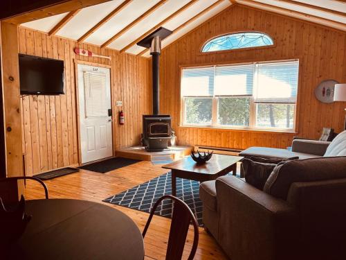 a living room with a couch and a stove at Stella by Starlight in Tobermory