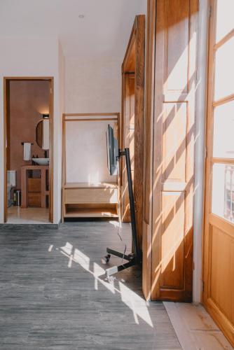 a room with a bed and a television and a door at Hotel Boutique Casa Yága in Querétaro