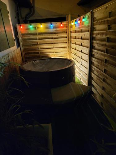 a lit up hot tub in a backyard with lights at La garrigue in Frontignan