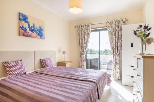 a bedroom with a large bed and a window at Vista Das Ondas 308 By RS in Olhos de Água