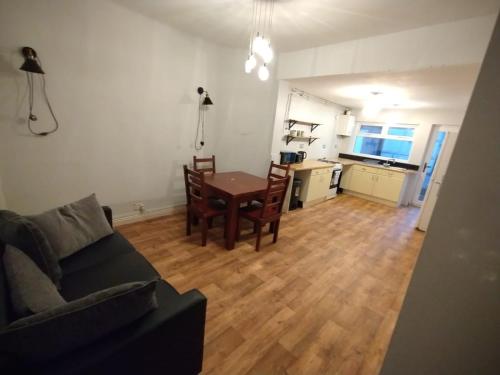 a living room with a couch and a table and a kitchen at Double-Bed Manchester Close To Bolton City Centre C4 in Little Hulton