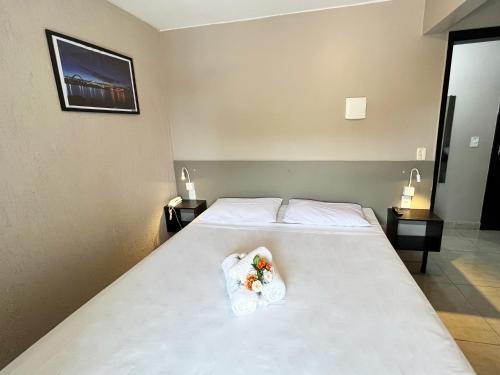 a bedroom with a bed with towels on it at Hotel Montana Aeroporto by Bsb Inn in Brasilia