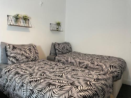 a bedroom with a bed and a couch with a blanket at House in Central Bournemouth in Bournemouth