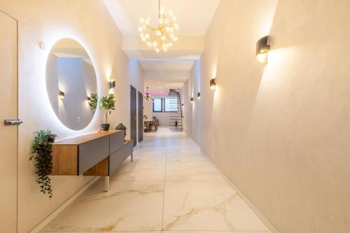 un couloir avec un miroir sur le mur et un long couloir dans l'établissement Bliss Triplex - Hyper Centre - Sauna - BBQ - Jacuzzi - LRACANNES, à Cannes