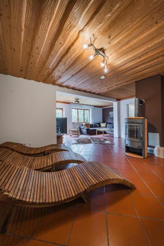a large living room with a wooden ceiling at Dachstein Chalet - Mountain view in Bad Goisern